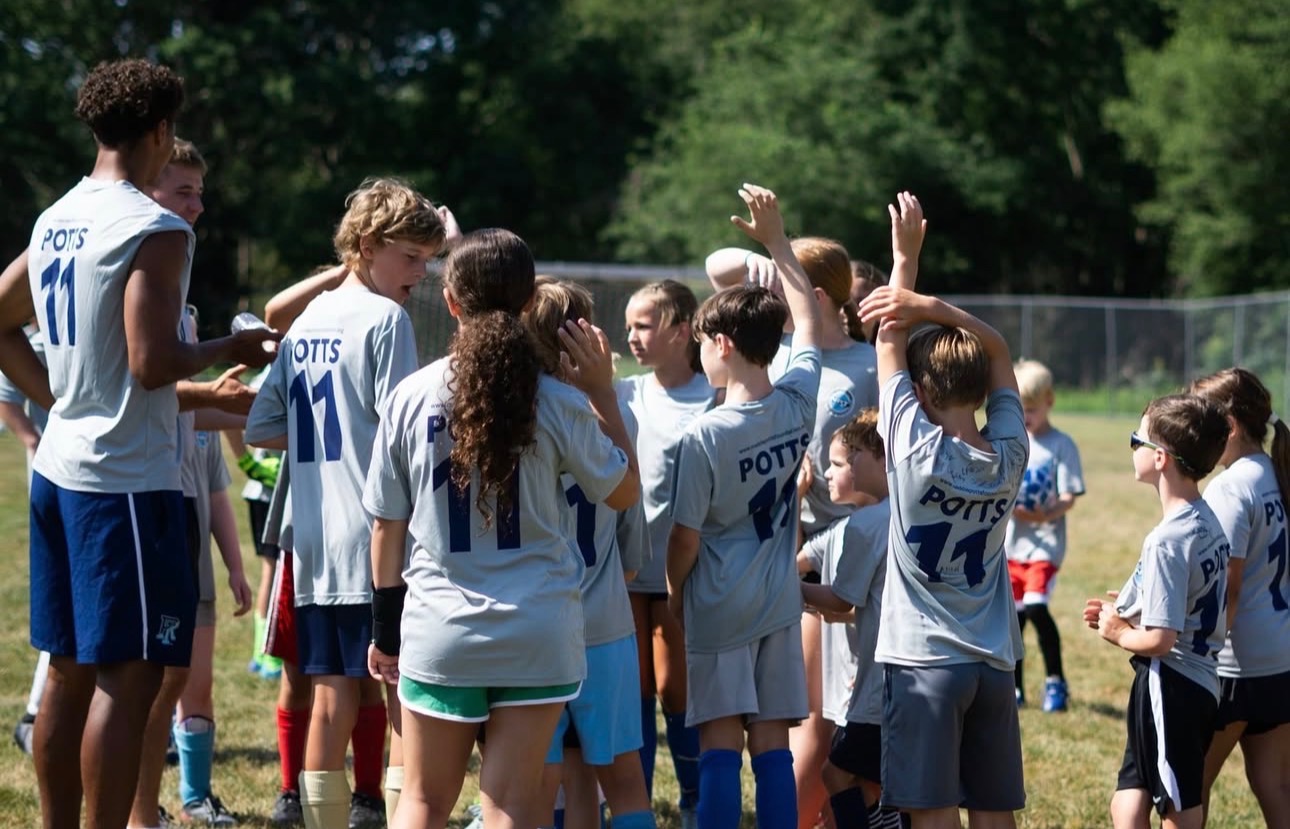 Camp team huddle with coaches